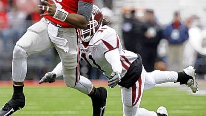 Ohio State quarterback Terrelle Pryor runs for a first down as New Mexico State linebacker Jamar Cotton chases him during the second quarter of Saturday's game in Columbus, Ohio.