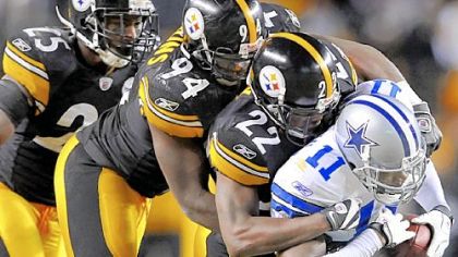 William Gay (22), (94) Lawrence Timmons (94) and Ryan Clark gang tackle the Cowboys wide receiver Roy Williams Dec. 7 at Heinz Field.