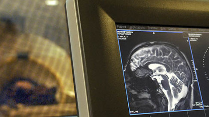 The PG's Mark Roth undergoes an fMRI brain scan as part of an analysis to identify brain activity linked to thinking about certain words. He is on left behind screened glass in MRI room. His scan is on right.