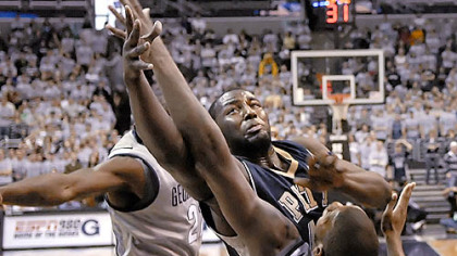 DeJuan Blair muscles his way over Georgetown's Greg Monroe for one of his 17 rebounds yesterday in Pitt's dominating performance at the Verizon Center in Washington.