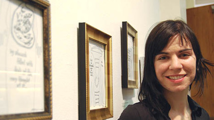 Ally Reeves with drawings from the exhibit Falling In at the American Jewish Museum.