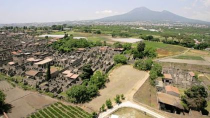 An aerial view of the ancient Roman town of Pompeii, near Naples in southern Italy. In the background is the volcano Mount Vesuvius.