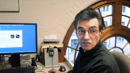 Dr. Marcel Just, Director of CMU Center for Cognitive Brain Imaging, checks on the computer's predictions on words that the PG's Mark Roth was thinking  while undergoing an fMRI brain scan.